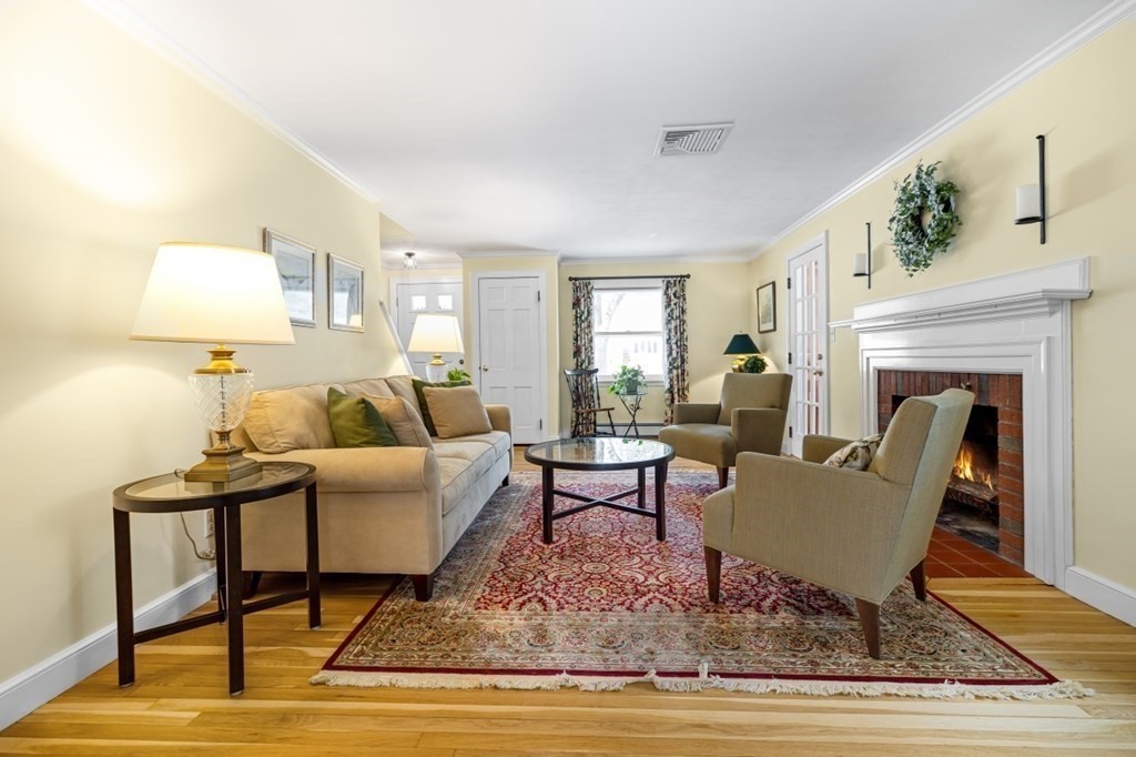 6 Sherman's Bridge Road Wayland, MA 01778 - Photo 8 of 42 a living room with furniture and a fireplace
