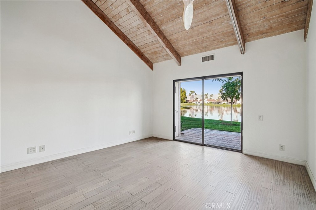 380 Wimbledon Drive Rancho Mirage, CA 92270 - Photo 19 of 41 a view of an empty room with wooden floor and door