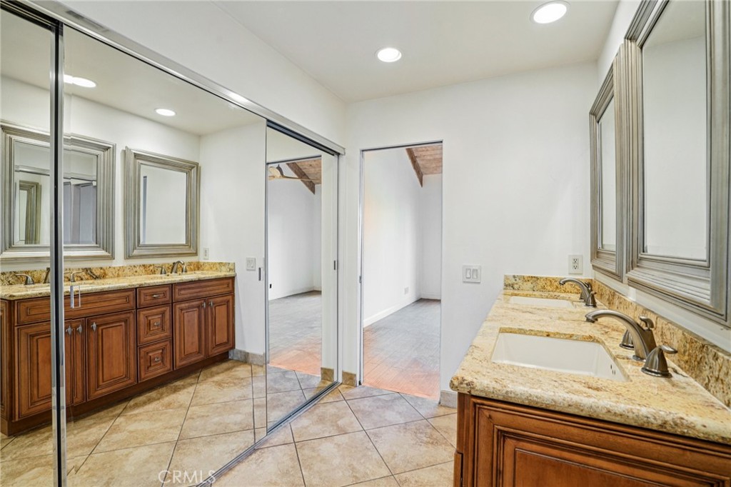 380 Wimbledon Drive Rancho Mirage, CA 92270 - Photo 24 of 41 a spacious bathroom with a granite countertop sink a mirror and a bathtub