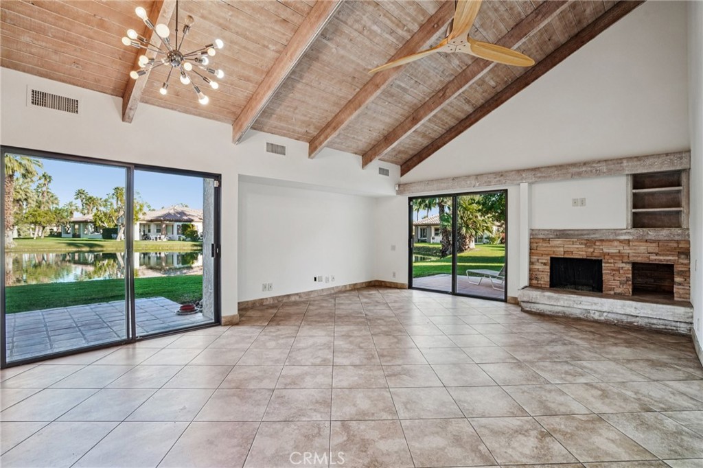 380 Wimbledon Drive Rancho Mirage, CA 92270 - Photo 9 of 41 a view of an empty room with a fireplace and a window