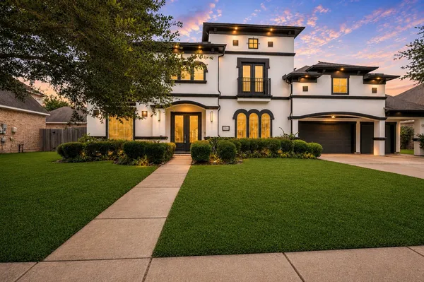 a front view of a house with a garden