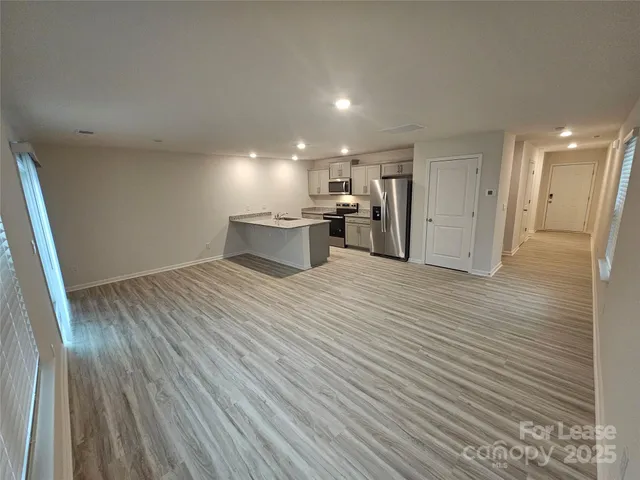 a view of a kitchen with wooden floor