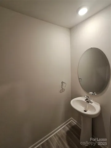 a bathroom with a sink toilet and mirror