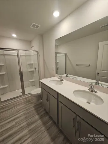 a bathroom with double vanity sink and a mirror