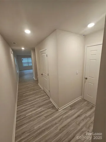 a view of hallway with wooden floor