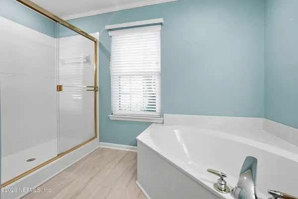 a bathroom with a tub and a shower