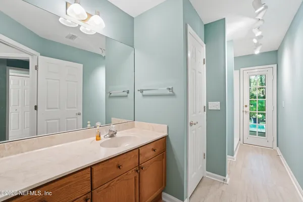 a bathroom with a sink a vanity and a mirror