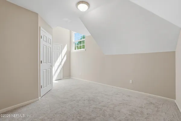 a bed room with a bed and a chandelier