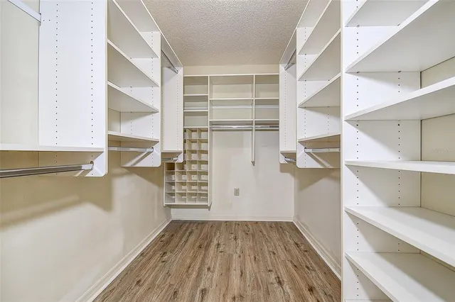 a view of walk in closet with empty racks