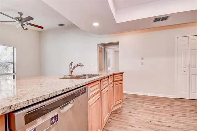 a hallway with sink and wooden floor