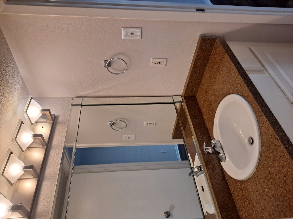 2018 West Rundberg Lane, Unit 9B Austin, TX 78758 - Photo 11 of 23 Bathroom with vanity, a textured wall, and a textured ceiling
