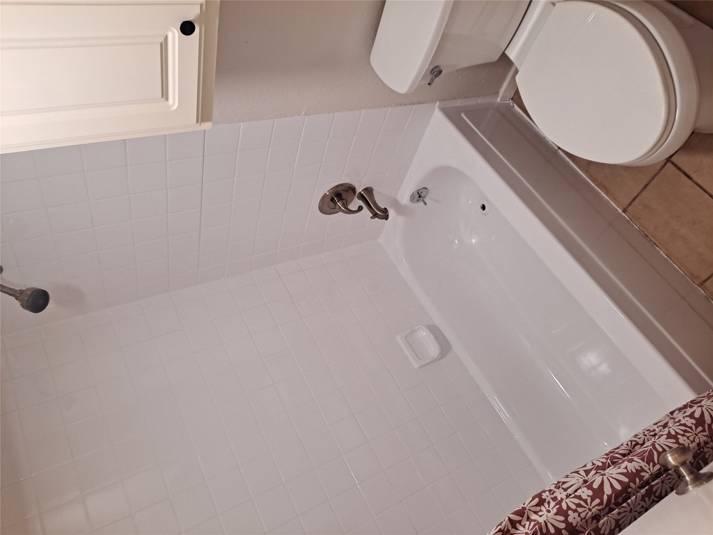 2018 West Rundberg Lane, Unit 9B Austin, TX 78758 - Photo 12 of 23 Full bath with tile patterned flooring and shower combination