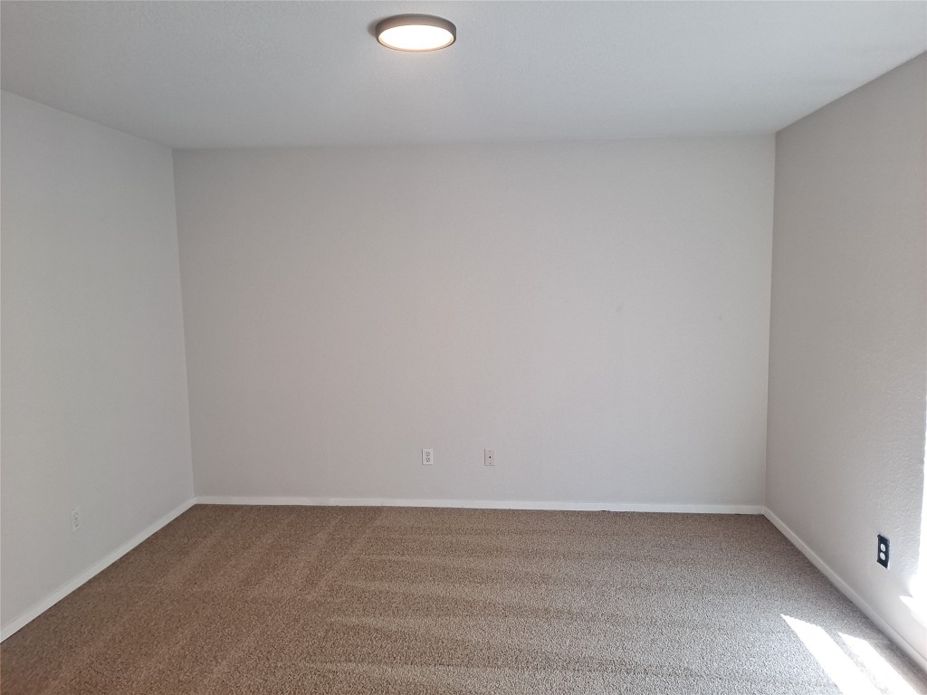 2018 West Rundberg Lane, Unit 9B Austin, TX 78758 - Photo 14 of 23 Carpeted empty room with baseboards