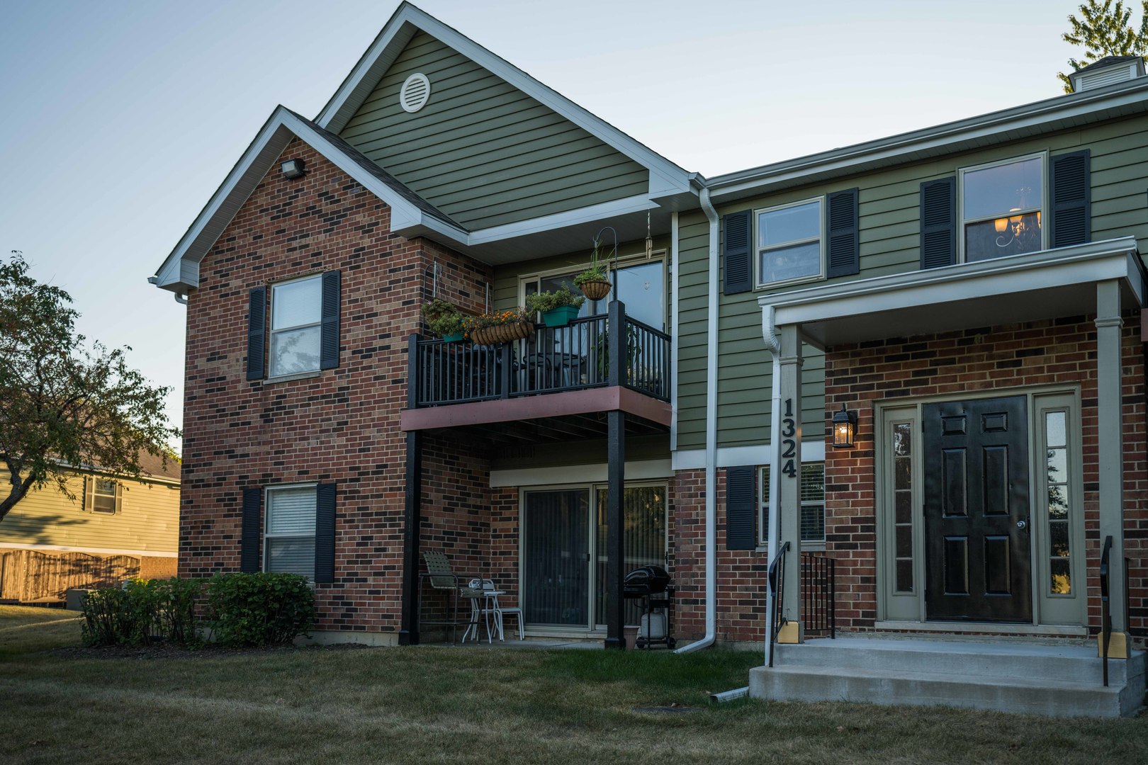 1324 McDowell Road, Unit 203 Naperville, IL 60563 - Photo 1 of 19 a front view of a house with a garden