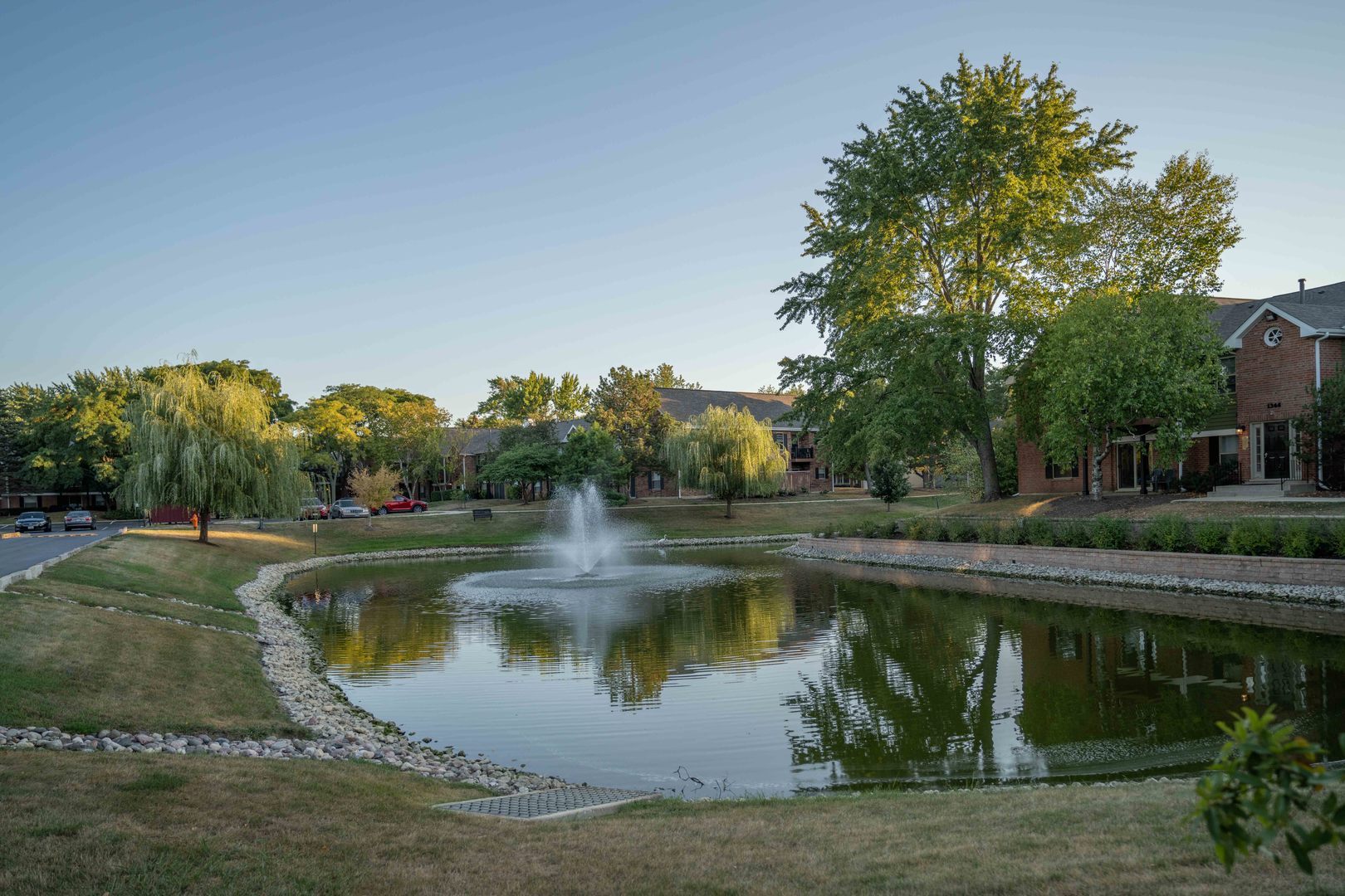 1324 McDowell Road, Unit 203 Naperville, IL 60563 - Photo 17 of 19 a view of a lake with a house in the background