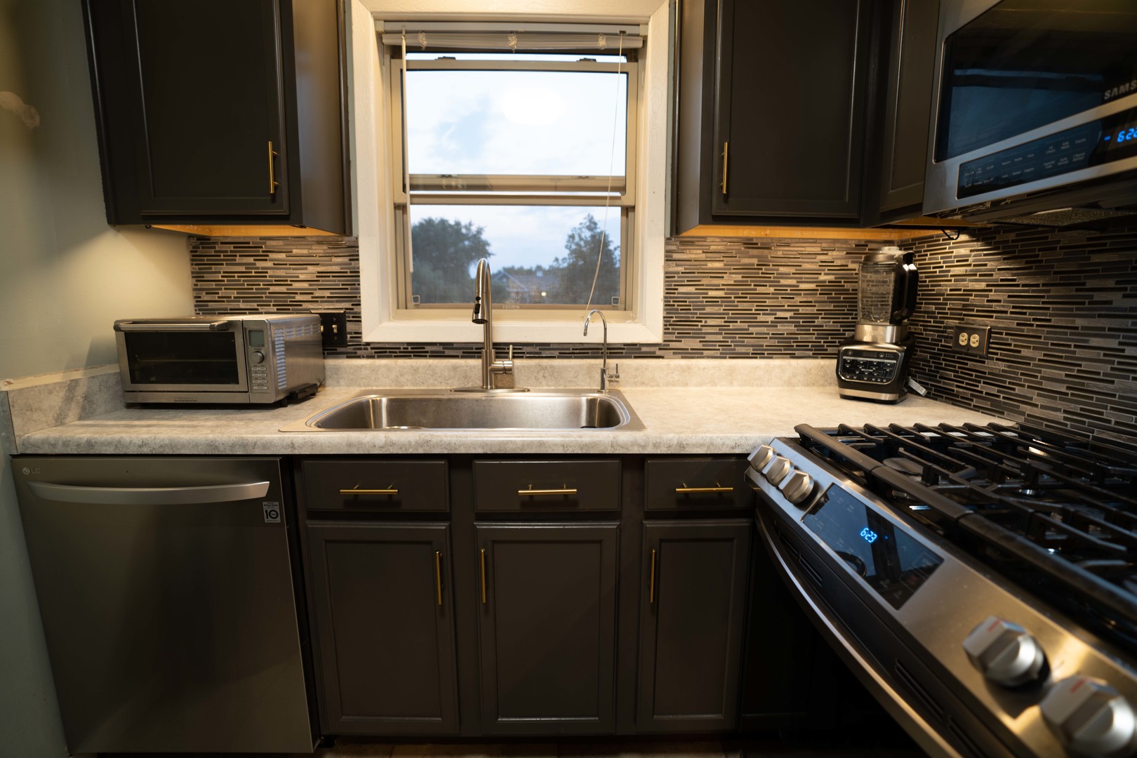 1324 McDowell Road, Unit 203 Naperville, IL 60563 - Photo 7 of 19 a kitchen with granite countertop a sink stainless steel appliances and cabinets