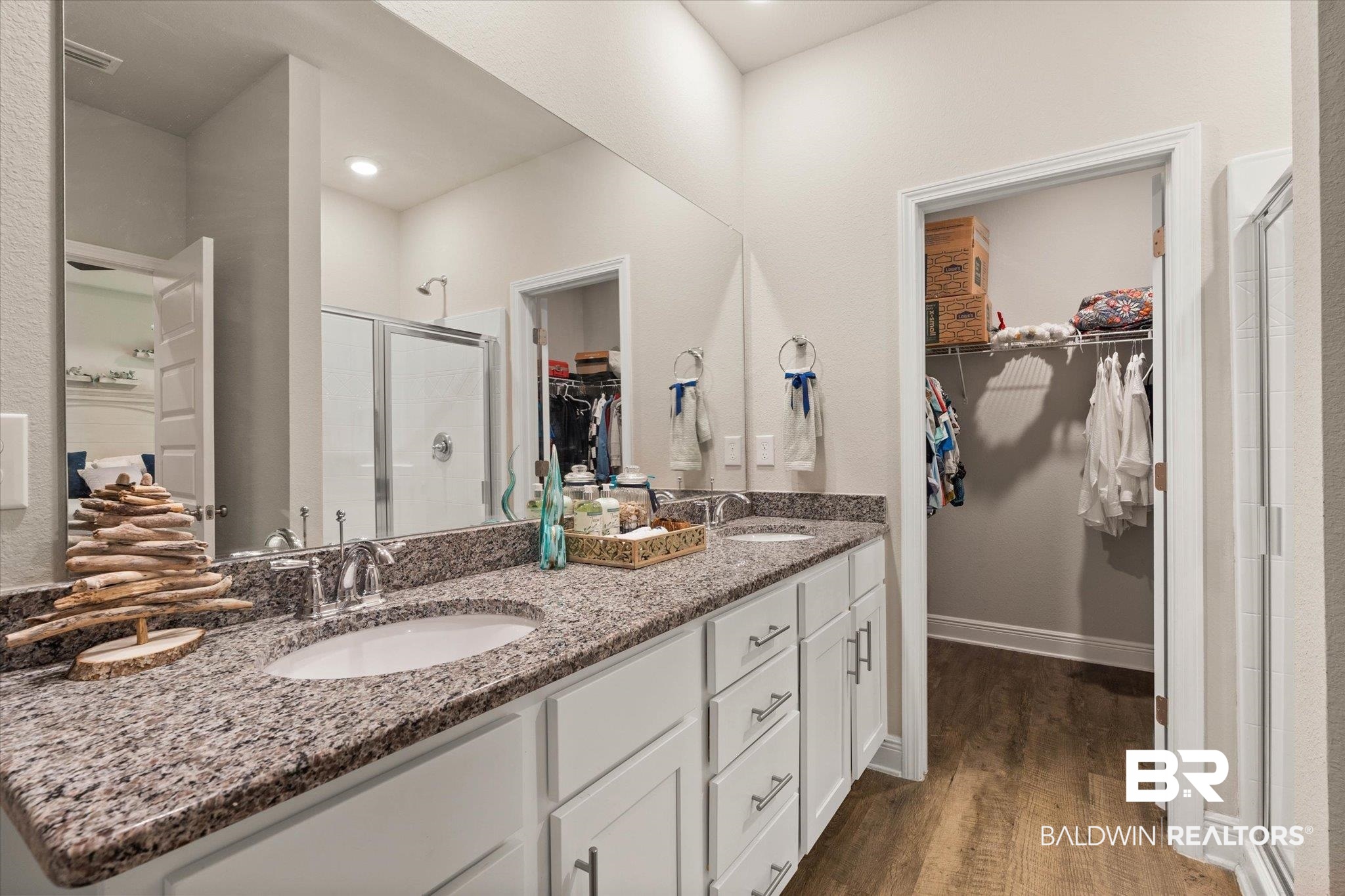 9037 Impala Drive Foley, AL 36535 - Photo 6 of 21 Bathroom with a stall shower, a walk in closet, double vanity, and wood finished floors