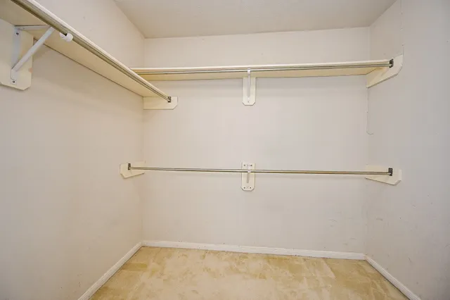 a bathroom with a granite countertop sink a mirror and a shower