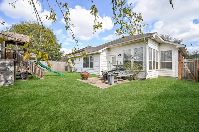 a view of a park with slide and a bench