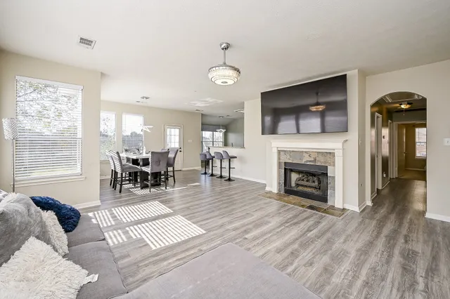 a living room with furniture a fireplace and a flat screen tv