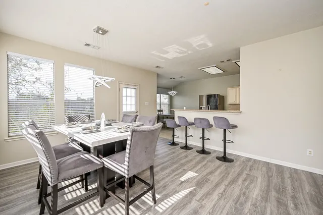 a front view of a house with swing and slide