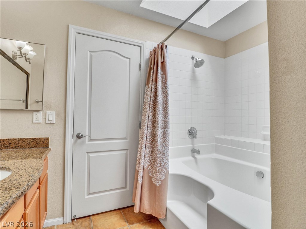 3145 East Flamingo Road, Unit 2129 Las Vegas, NV 89121 - Photo 19 of 43 A skylit bathtub and shower combination create a light-filled bathing experience.