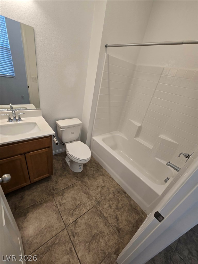 4748 Ritual Street North Las Vegas, NV 89031 - Photo 29 of 31 A well-appointed bathroom features a practical vanity and a pristine shower-over-tub combination.