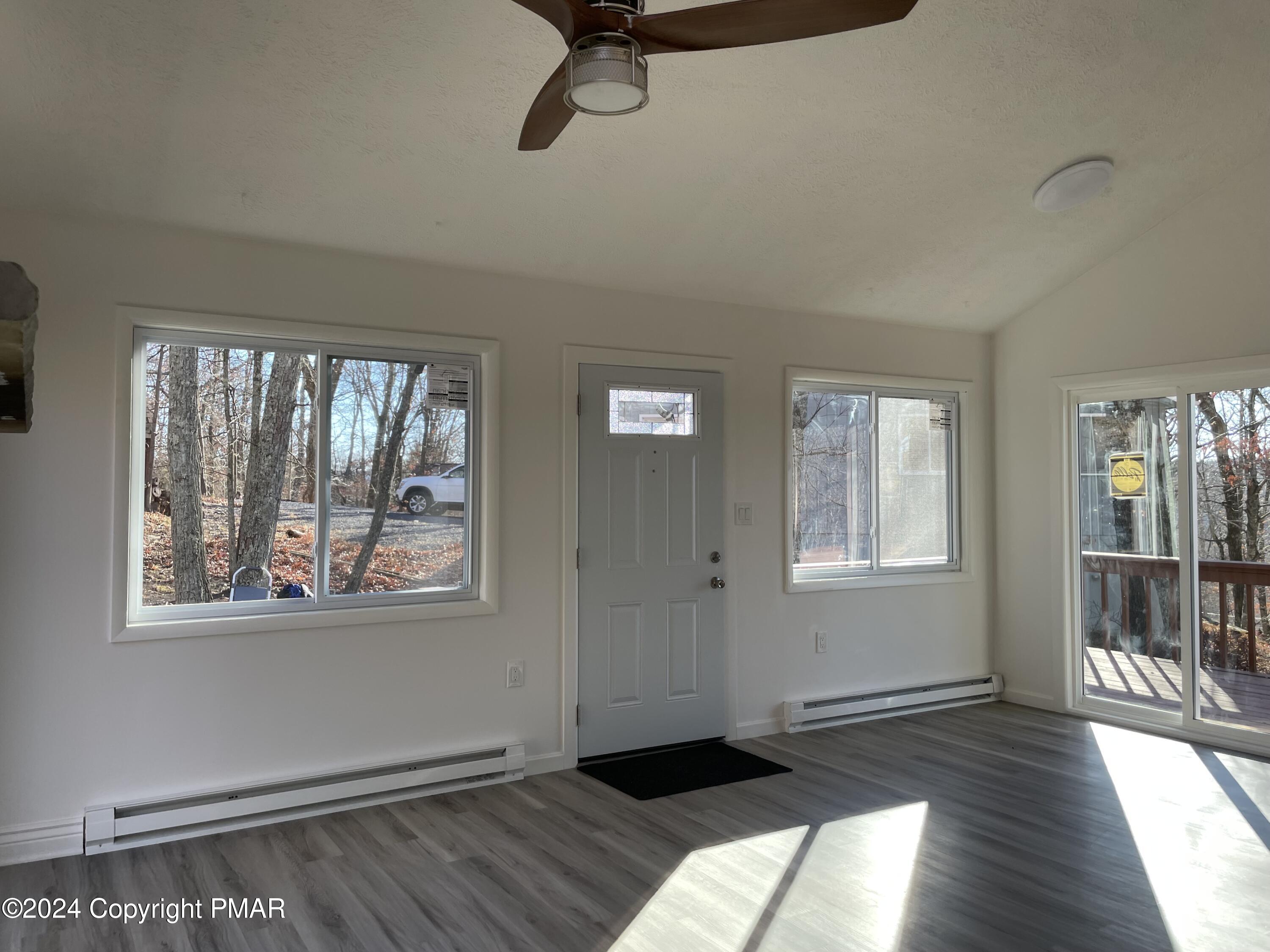 2204 Exeter Court Bushkill, PA 18324 - Photo 13 of 29 a view of a big room with wooden floor and windows