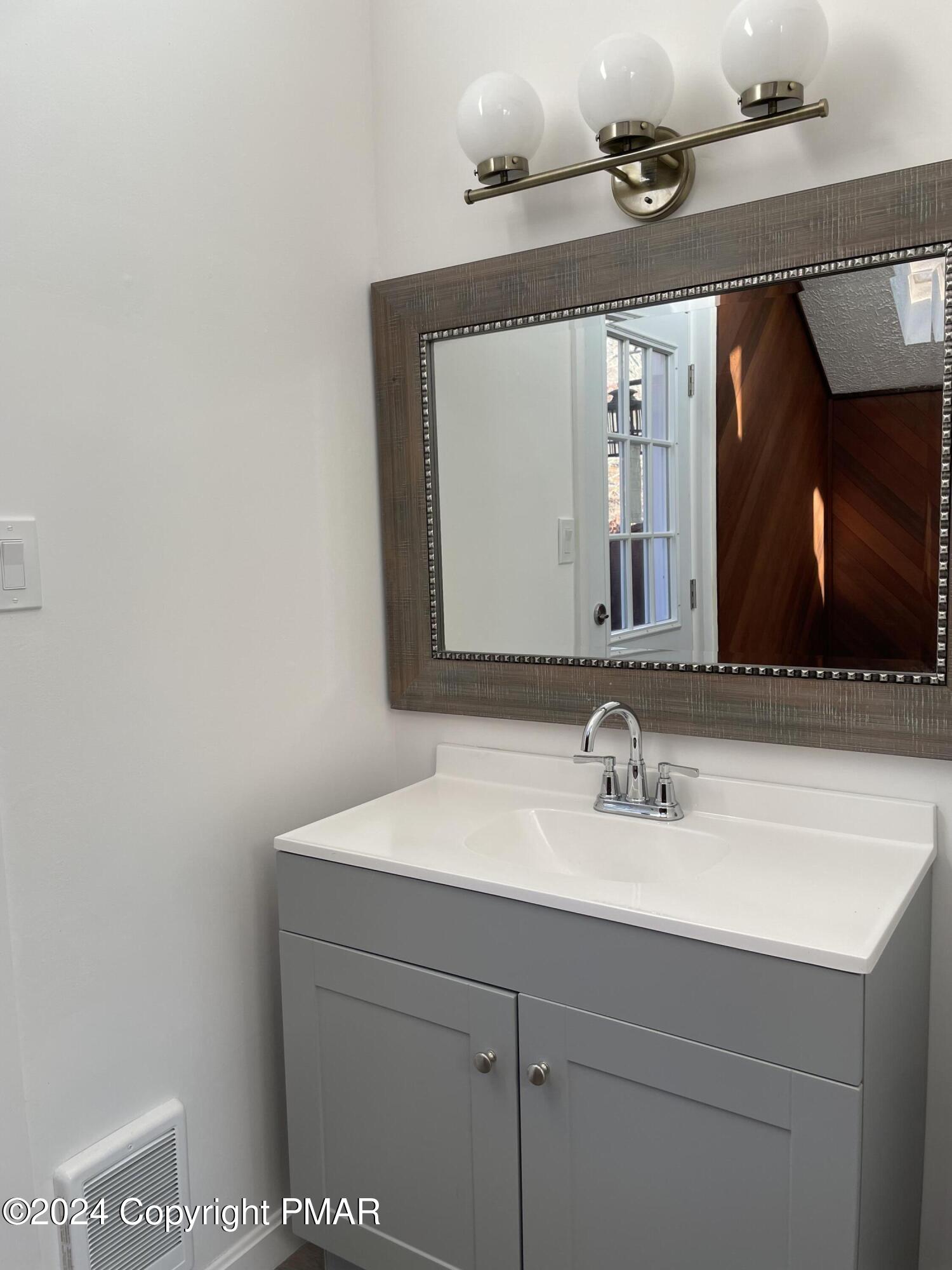 2204 Exeter Court Bushkill, PA 18324 - Photo 21 of 29 a bathroom with a sink vanity and a mirror