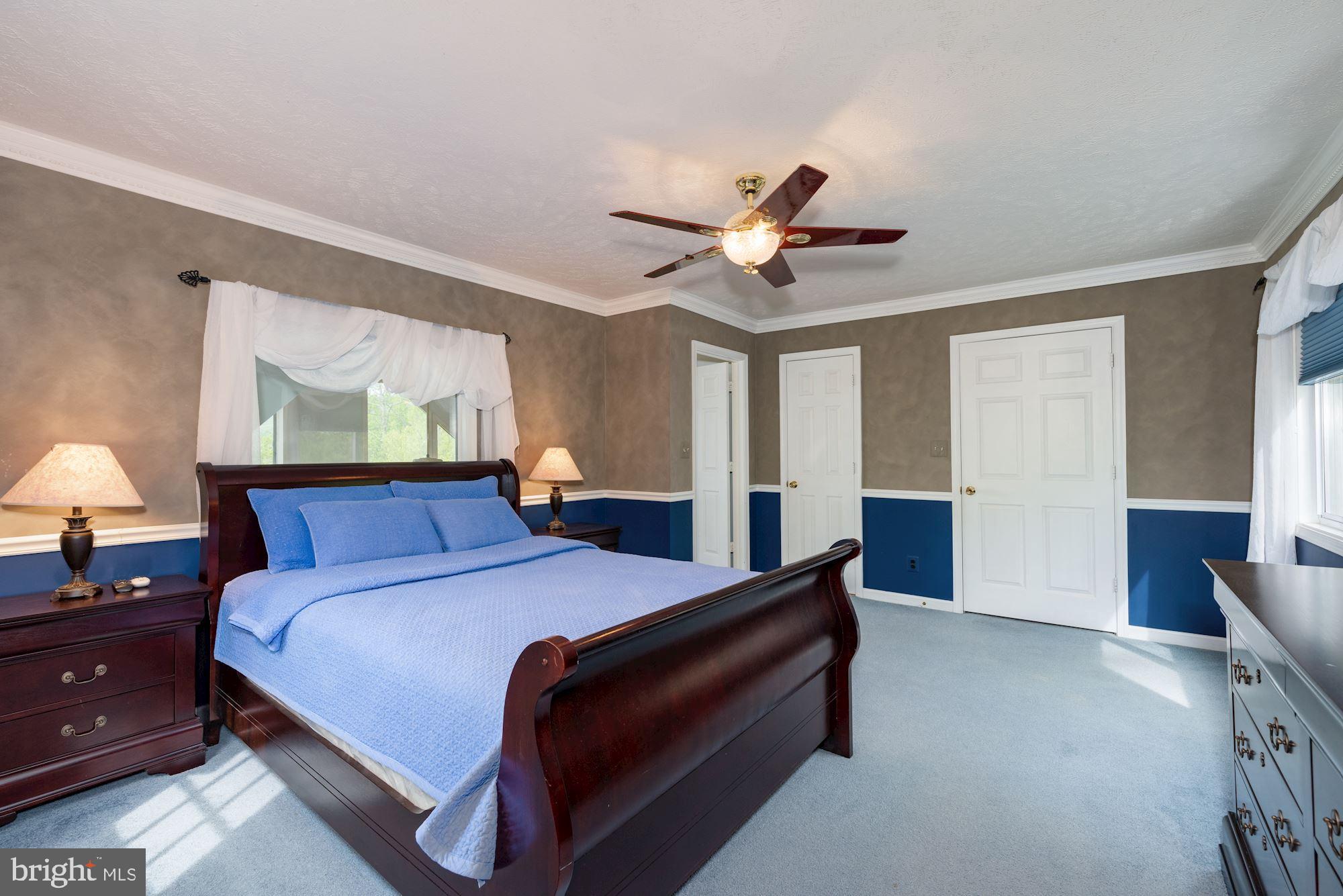 781 River Vw Road Rileyville, VA 22650 - Photo 10 of 16 a bedroom with a bed and a chandelier