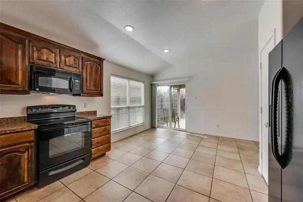 a view of a kitchen with microwave and stove top oven