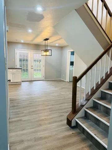 a view of entryway and hall with wooden floor