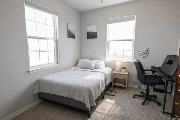 a bedroom with a bed chair and a window