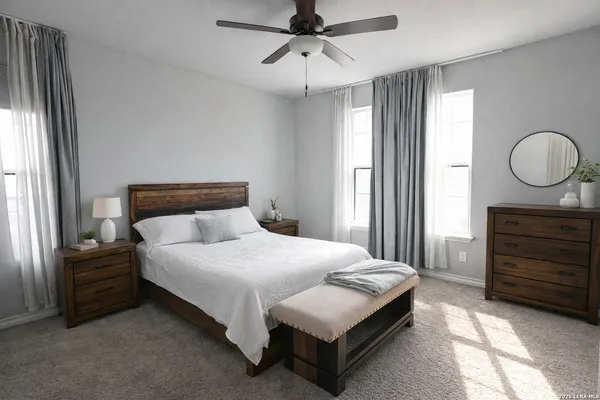 a bedroom with a bed a dresser and a window