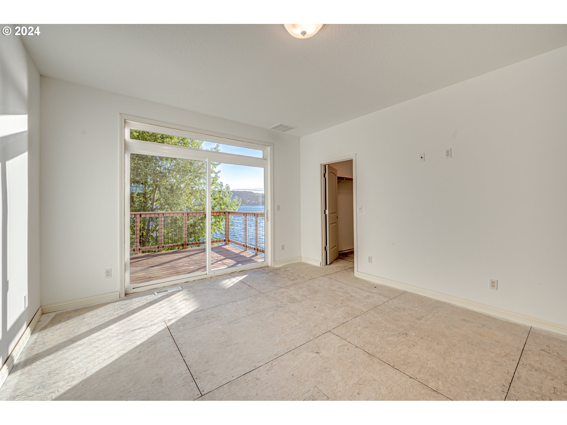 2825 Dike Road Woodland, WA 98674 - Photo 17 of 48 a view of an empty room with wooden floor and a window