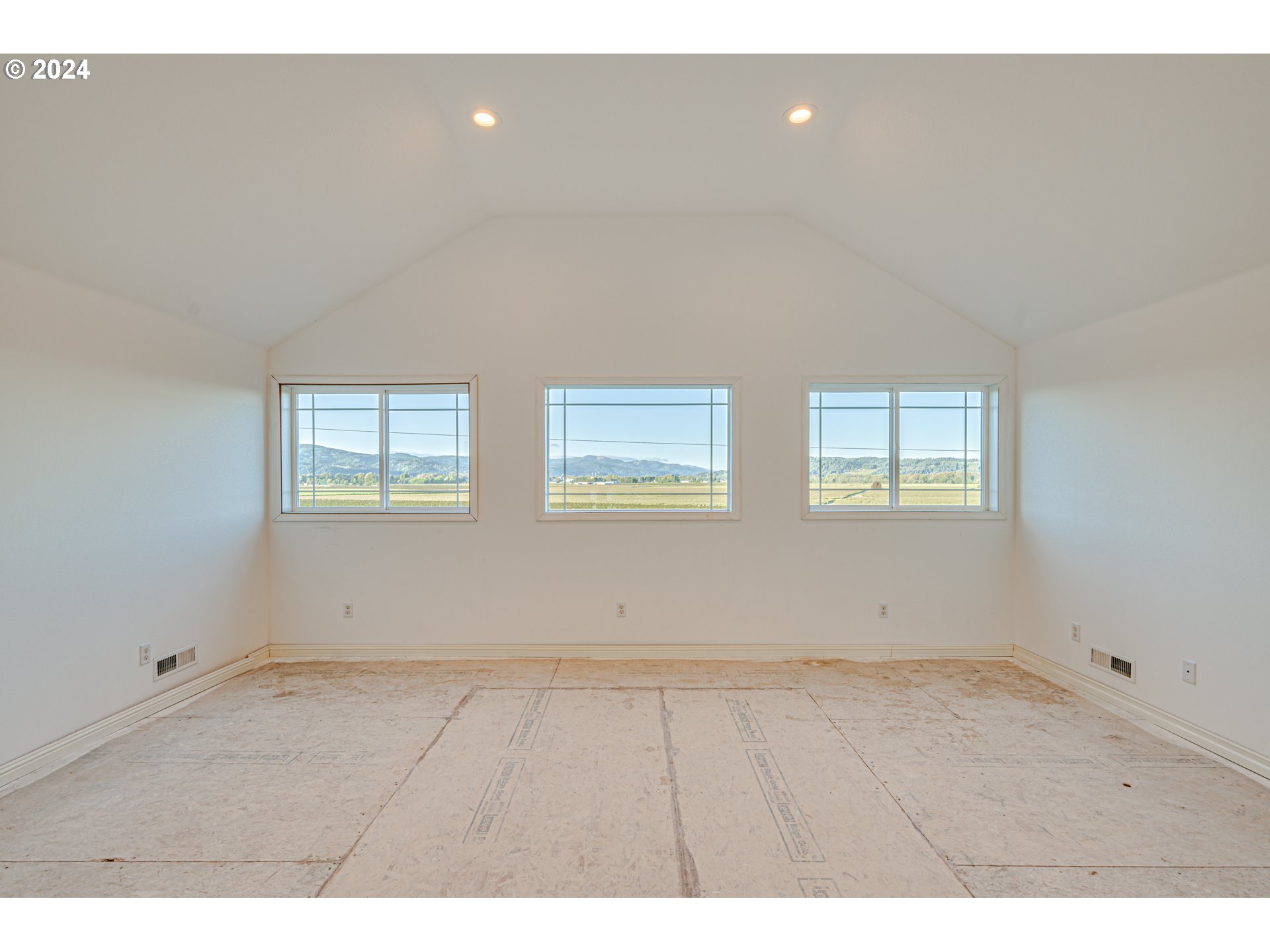 2825 Dike Road Woodland, WA 98674 - Photo 30 of 48 a view of an empty room with wooden floor and windows