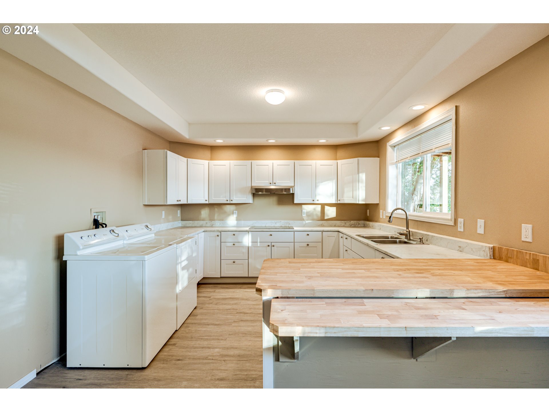 2825 Dike Road Woodland, WA 98674 - Photo 39 of 48 a large white kitchen with a sink and dishwasher a stove with wooden floor