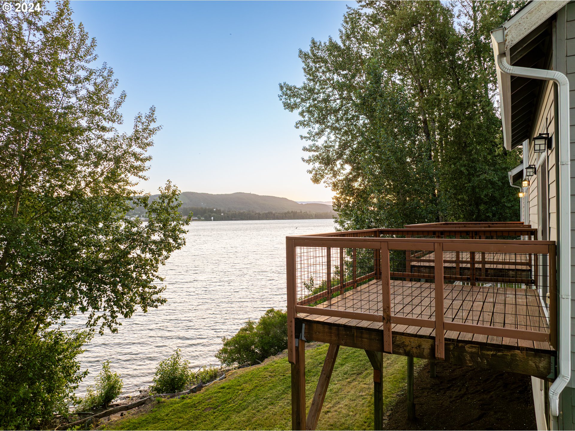 2825 Dike Road Woodland, WA 98674 - Photo 45 of 48 a balcony with table and chairs with wooden floor and fence