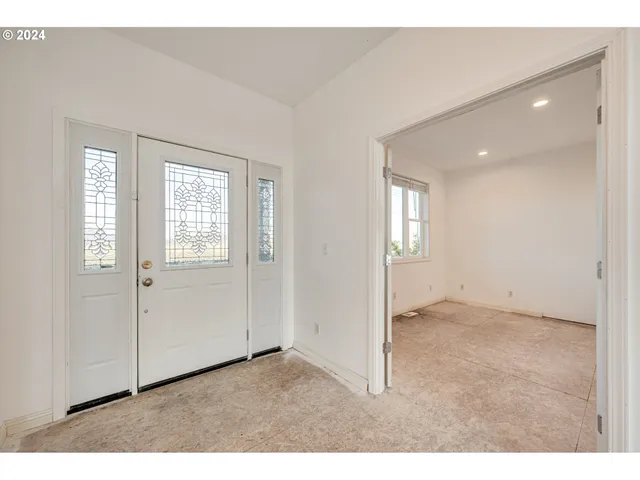 an empty room with windows and closet