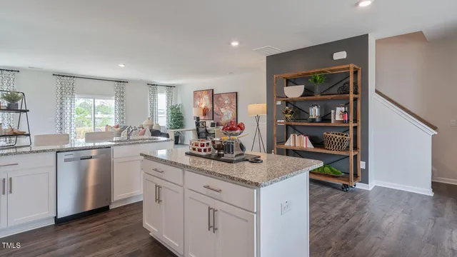 a kitchen with refrigerator a sink a stove and cabinets