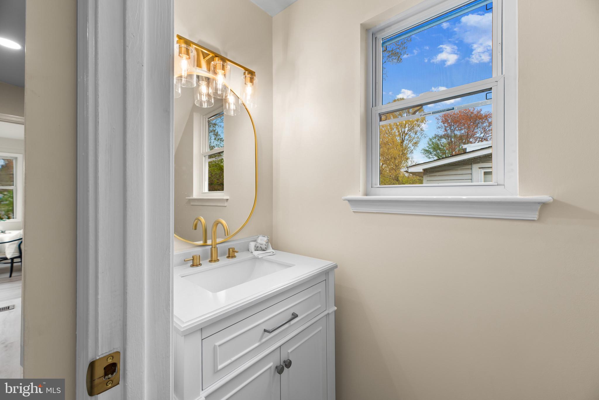 1512 Lincoln Road Shady Side, MD 20764 - Photo 23 of 42 a bathroom with a sink mirror and window