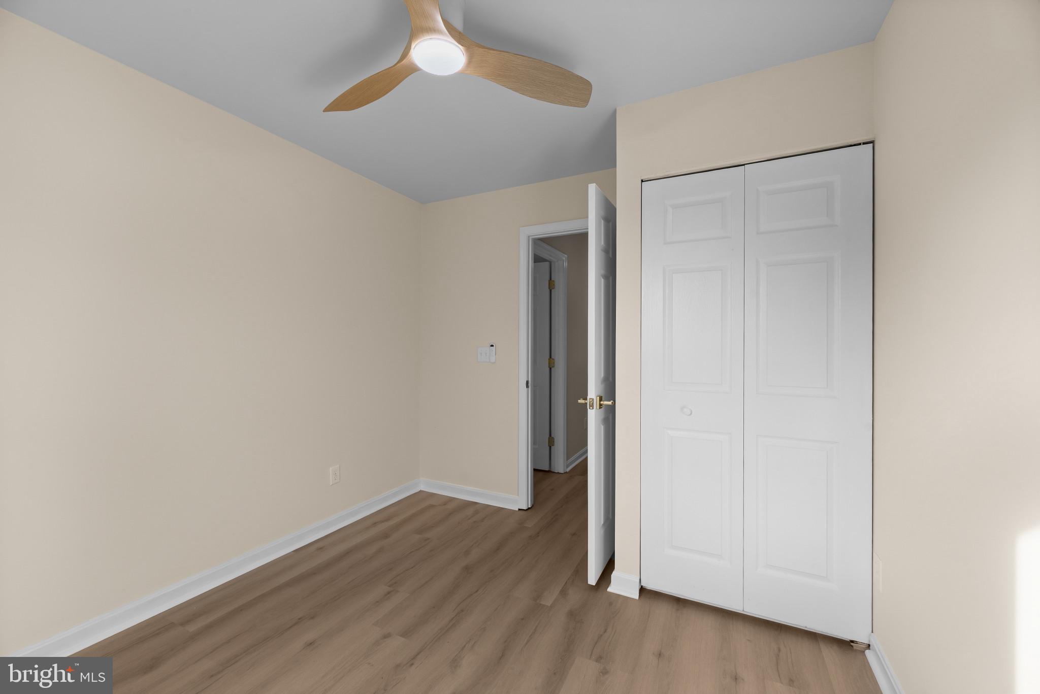 1512 Lincoln Road Shady Side, MD 20764 - Photo 26 of 42 an empty room with wooden floor and closet