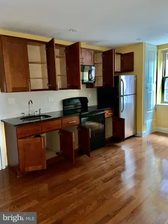 a kitchen with stainless steel appliances granite countertop a refrigerator and a stove top oven