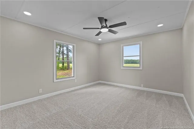 an empty room with closet and a chandelier fan