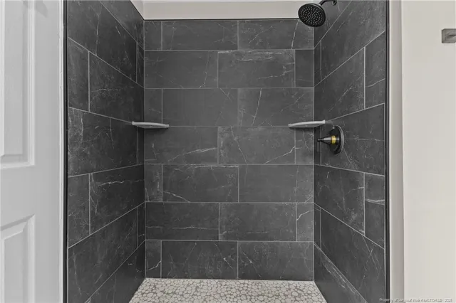 a bathroom with a tub a sink and mirror