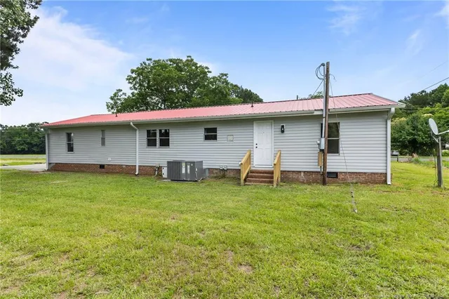 a front view of house with yard and trees