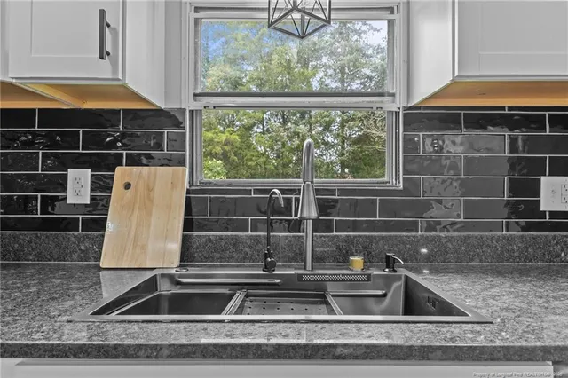 a kitchen with stainless steel appliances granite countertop a refrigerator sink and cabinets
