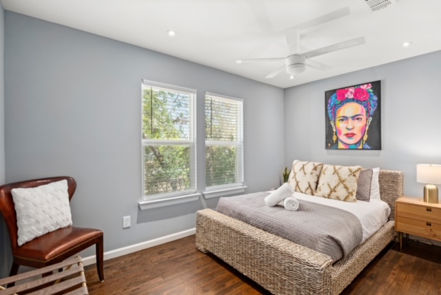 1183 Coleto Street Austin, TX 78702 - Photo 14 of 17 a bedroom with a bed and wooden floor