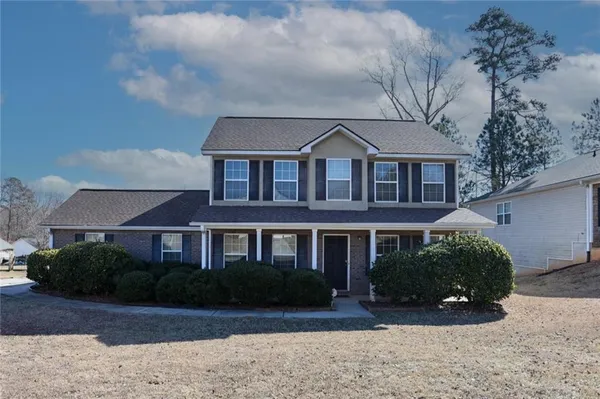 a front view of a house with a yard