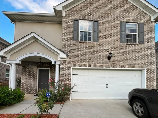 a front view of a house with parking space